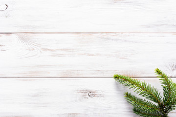 Christmas white wooden background with christmas fir on rustic wood, flatlay, top view