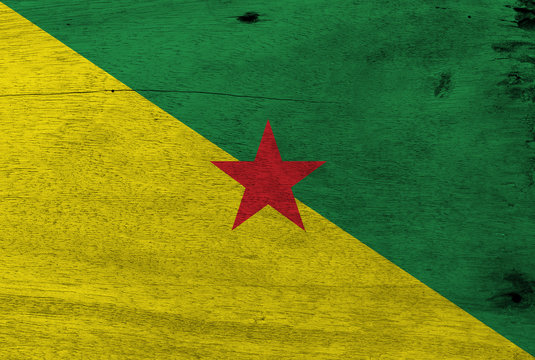 Flag of French Guiana on wooden plate background. Grunge French Guiana flag texture, The green and yellow with red star. - Powered by Adobe