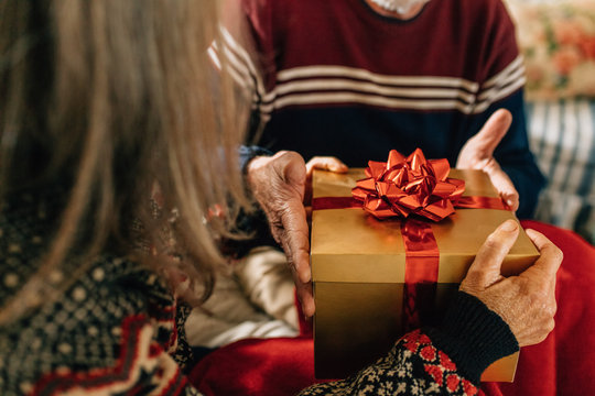 Elderly couple exchanging gifts