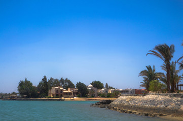 Beautiful view of the coastline with houses and hotels on the red sea. Tourist region in Egypt. Hurghada and its traditions. Stock photo for design