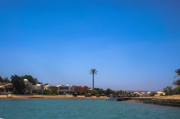 Fototapeta na wymiar Beautiful view of the coastline with houses and hotels on the red sea. Tourist region in Egypt. Hurghada and its traditions. Stock photo for design