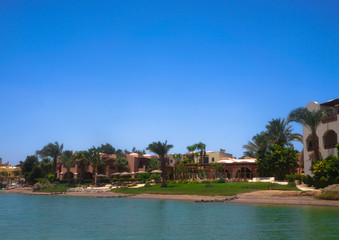 Obraz premium Beautiful view of the coastline with houses and hotels on the red sea. Tourist region in Egypt. Hurghada and its traditions. Stock photo for design