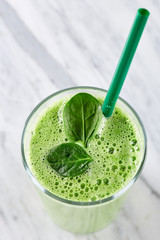 Smoothie. A glass full of refreshing healthy milk smoothie made from various fruit. Spinach, broccoli, kiwi