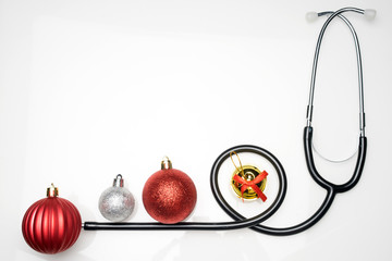 Christmas in the healthcare industry. Top view of flat lay. Stethoscope with ornaments carries an...