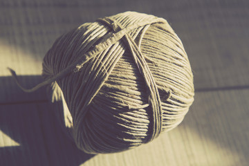 Vintage Style Image of Still life with rustic rope ball on the w