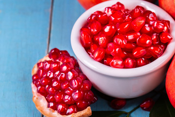 Ripe pomegranate fruits on the wooden background