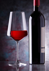 red wine glass and bottle