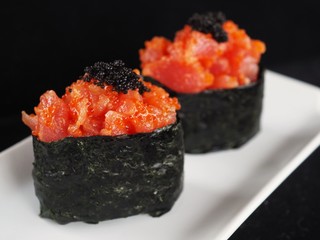 Close up delicious sushi over dark background copy space.