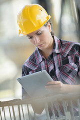female engineer using tablet outdoors at construction site
