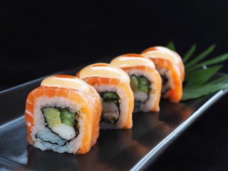 Close up delicious sushi over dark background copy space.