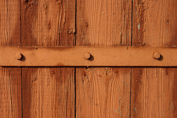 Painted door hinges on garage door. Old wooden boards. Background. Close-up 