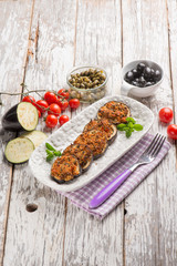 baked eggplant filled with caper tomatoes and black olives