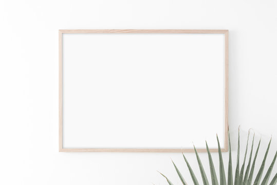 Landscape large 50x70, 20x28, a3,a4, Wooden frame mockup on white wall. Palm leaves. Poster mockup. Clean, modern, minimal frame. Empty fra.me Indoor interior, show text or product