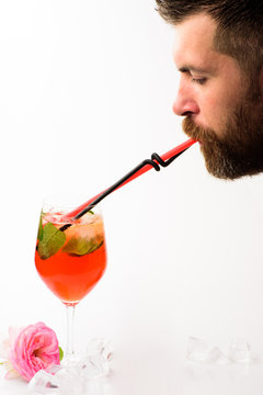 Man Drink Cocktail From Glass. Bearded Man Drinkiing Cocktail With Straw Isolated On White. Summer Refresh. Alcoholic And Non Alcoholic Drinks. Bar And Restairant. Feeling Thirst. I Like The Taste