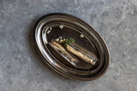Plate with garlic and razor clams