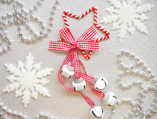Shining Christmas background - red star with bells, snowflakes and silver necklace