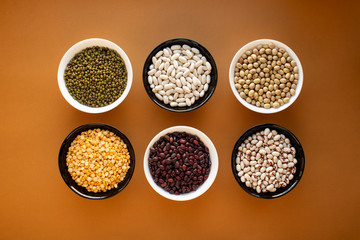 Different types of beans in bowls. Yellow pea, mung bean, red beans, yellow beans, black eye beans, white beans