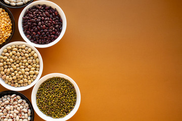 Different types of beans in bowls. Yellow pea, mung bean, red beans, yellow beans, black eye beans, white beans