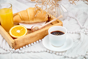 Good morning. Continental breakfast on white bed sheets.