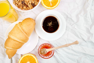 Good morning. Continental breakfast on white bed sheets.