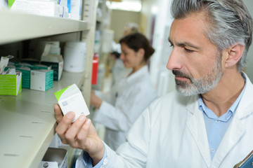 pharmacist checking medication in pharmacy