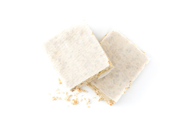 Typical christmas almond nougat isolated on white background. Top view