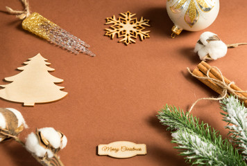  inscription, snowflake, Christmas decorations, green spruce branch,  cotton branch, artificial icicle, Christmas decorations, ball, cinnamon sticks, place for inscription on brown background