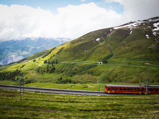 Obraz na płótnie Canvas Train Climbing Tracks to Kleine Scheidegg