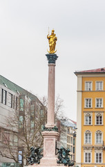 Fototapeta na wymiar The Golden statue of Mary (Mariensaule), a Marian column on the Marienplatz in Munich,Germany