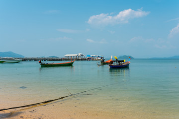 The slow boat ferry at the pier on the island Ko Phayam. The boat leaves the island Ko Phayam direction Rasnong 