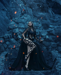 Medusa Gorgona Goddess turning a gaze into a stone. It stands against the background of rocks in...