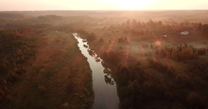 Aerial View. Panoramic Autumn landscape. The picturesque landscape with river, trees and field. Morning Fog. Aerial camera shot. Altai, Siberia.
