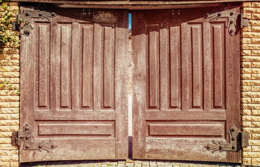 Wooden brown gate with rusty metal figure loops © domarevatanya