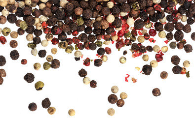 Mix of different peppers isolated on white background (black, red, green and white peppercorns)