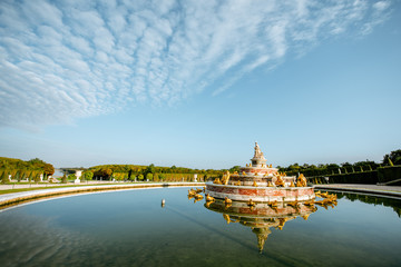 Versailles gardens with Latona fountain and Grand canal during the morning light in Versailles,...