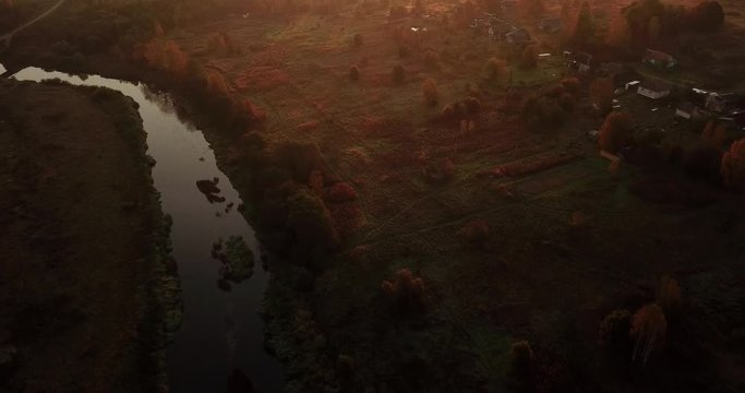 Aerial View. Panoramic Autumn landscape. The picturesque landscape with river, trees and field. Morning Fog. Aerial camera shot. Altai, Siberia.