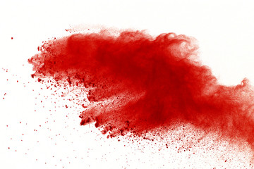 Red powder explosion on white background. Paint Holi.