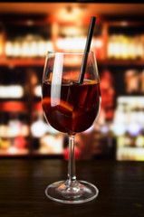 Red wine glass on wooden background
