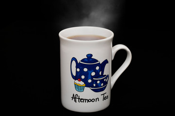 The word Afternoon tea on mug full of warm tea