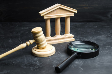 Magnifying glass lies near the courthouse. Lawsuits, verdict and bills. Constitutional Court. Human...