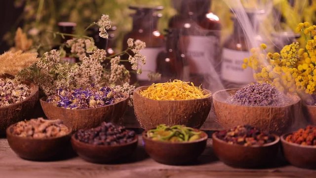Fresh medicinal herbs, smoke on wooden 