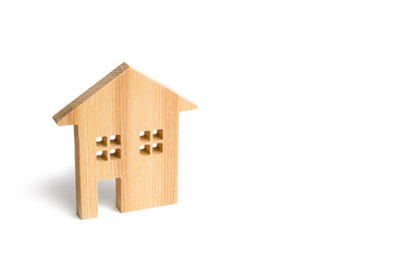 Wooden residential house on a white background. Mortgage and credit for the purchase. Minimalism. Isolate Real estate concept, buying affordable housing, selling real estate and renting. Property tax.