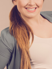 Unrecognizable woman smiling having long hair