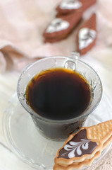Cup of coffee with cookies. on white wooden board.