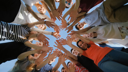 School class collection. The pupils wave their hands and run. College Students Teamwork Stacking...