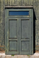 A High Dynamic Range image of a weathered green door in Venice Italy.