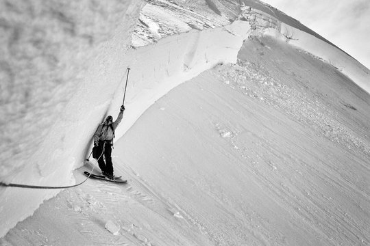 Skier standing next to a mountain of snow