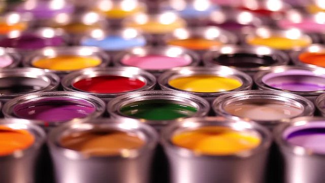 Buckets full of rainbow colored oil paint