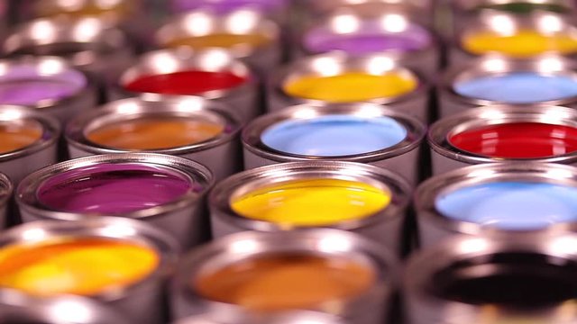 Buckets full of rainbow colored oil paint