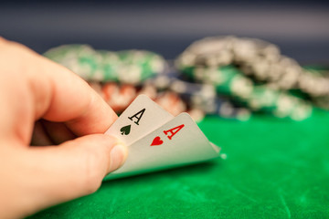 playing cards,dices and poker chips on green poker table
